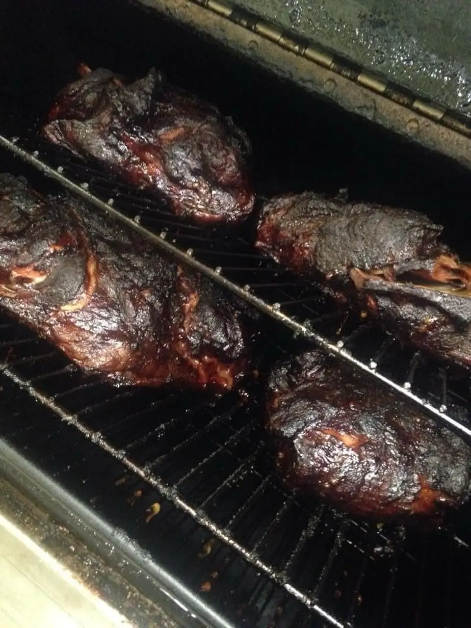 Meats smoking low and slow in the smoker