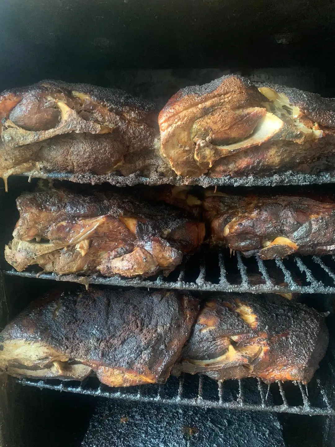 Brisket and ribs smoking on the grill